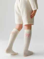 Omsa Гольфы OMSA kids Gambaletto 32P32 ажурные с имитацией рисунка ромб и бантика сзади Avorio (Молочный)